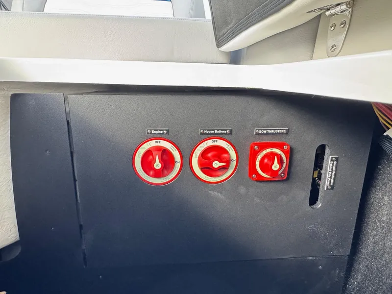 Slide: The Image of Control panel of 2025 Regal LS9 Surf boat with red switches. - 59