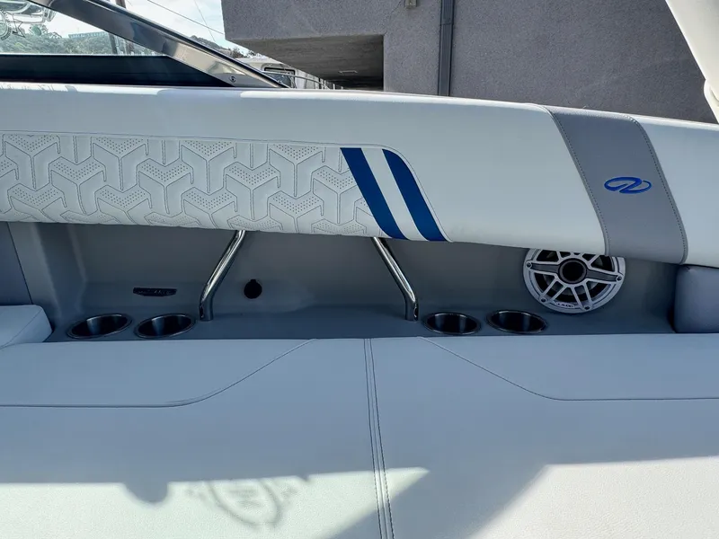 Slide: The Image of 2025 Regal LS9 Surf boat interior with cup holders and speaker. - 62