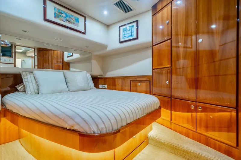 Slide: The Image of Luxurious cabin interior of 2001 Bertram 510 Convertible yacht with polished wood finish. - 16
