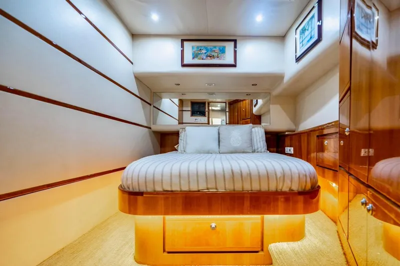 Slide: The Image of Luxurious cabin interior of 2001 Bertram 510 Convertible yacht with elegant wood finishes. - 17