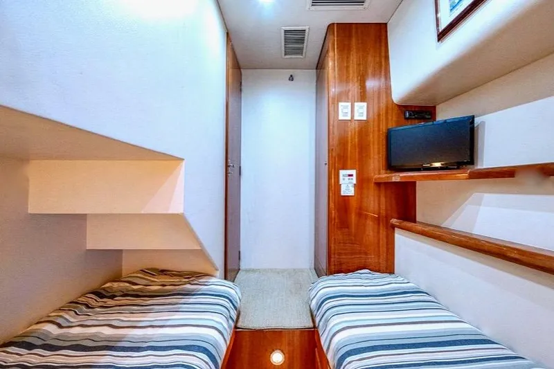 Slide: The Image of Interior cabin of 2001 Bertram 510 Convertible yacht with twin beds and TV. - 25
