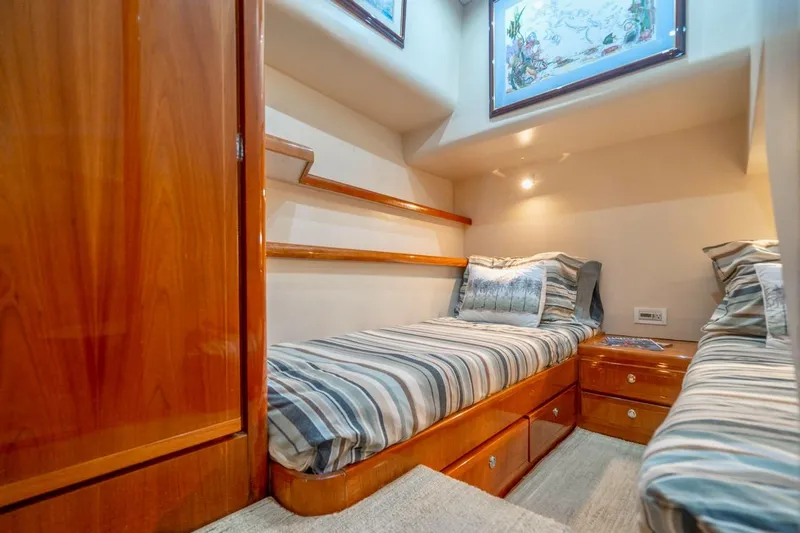 Slide: The Image of Interior cabin of 2001 Bertram 510 Convertible yacht with twin beds and wooden furnishings. - 26