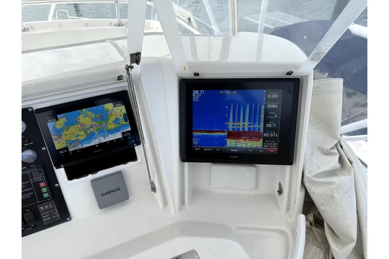 Slide: The Image of Garmin navigation and sonar displays on a 2001 Bertram 510 Convertible boat dashboard. - 30