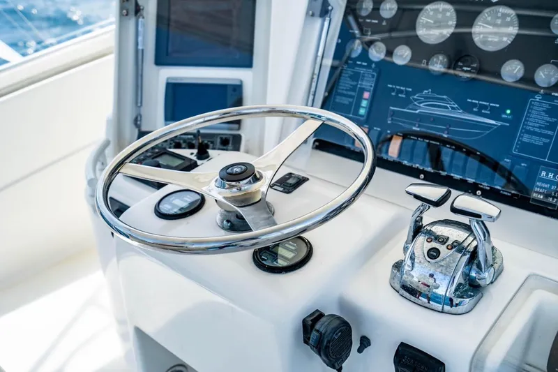 Slide: The Image of Control panel of a 2001 Bertram 510 Convertible yacht with steering wheel and gauges. - 32