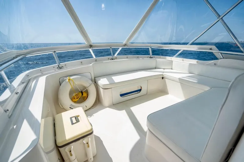 Slide: The Image of Interior view of 2001 Bertram 510 Convertible yacht with white seating and ocean backdrop. - 37