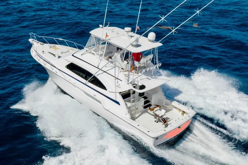 Slide: The Image of 2001 Bertram 510 Convertible yacht cruising on open blue ocean waters. - 40