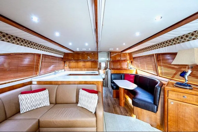 Slide: The Image of Luxurious interior of a 2001 Bertram 510 Convertible yacht with elegant wood finishes. - 7