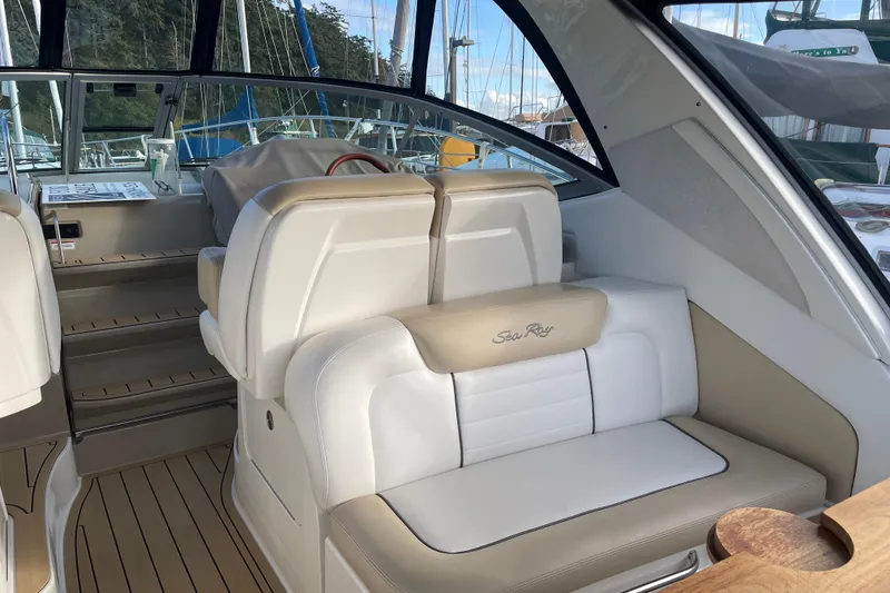 Slide: The Image of 2008 Sea Ray 330 Sundancer interior with white seating and wood accents. - 14