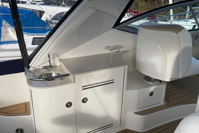 Slide: The Image of 2008 Sea Ray 330 Sundancer interior with sink and seating area. - 16