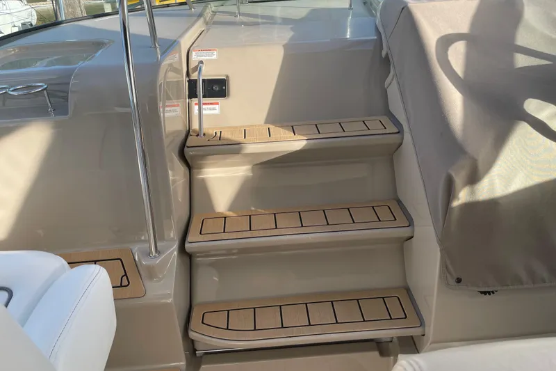 Slide: The Image of Steps leading to the helm of a 2008 Sea Ray 330 Sundancer boat. - 18
