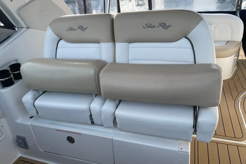 Slide: The Image of 2008 Sea Ray 330 Sundancer boat seating with beige and white upholstery. - 21