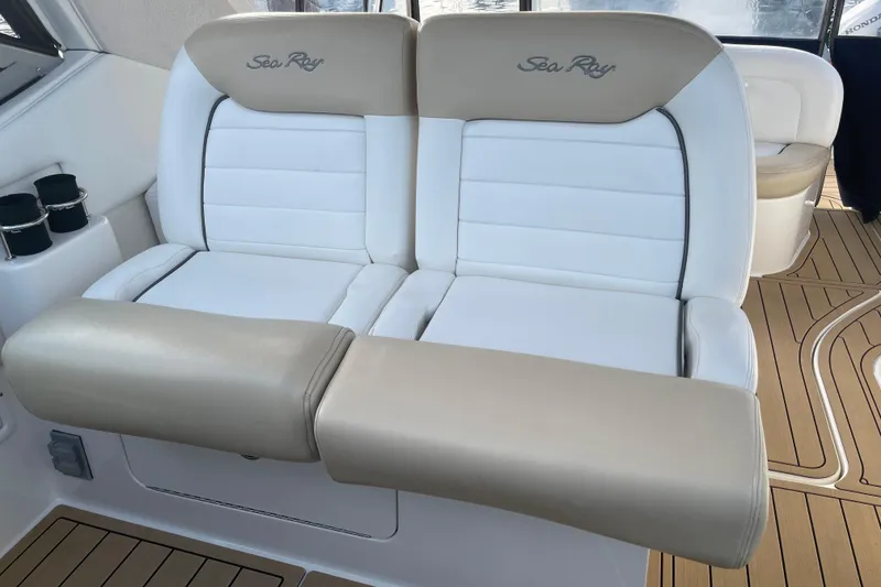 Slide: The Image of 2008 Sea Ray 330 Sundancer interior seating with beige and white upholstery. - 22