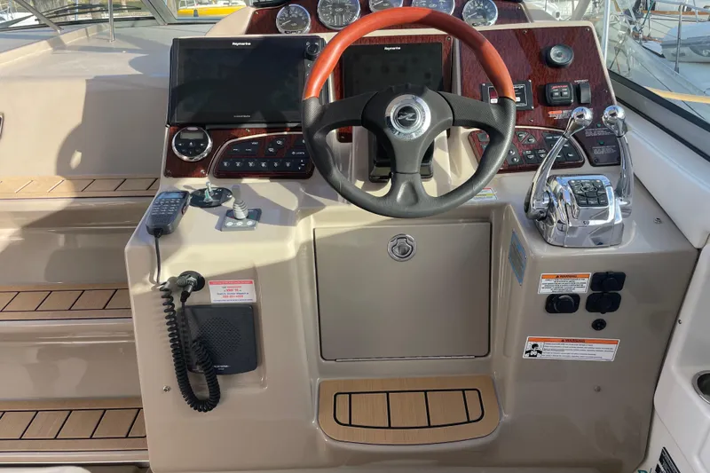Slide: The Image of 2008 Sea Ray 330 Sundancer helm with steering wheel, controls, and navigation equipment. - 23
