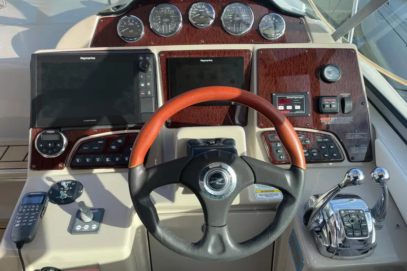 Slide: The Image of Cockpit of 2008 Sea Ray 330 Sundancer with steering wheel and navigation controls. - 24