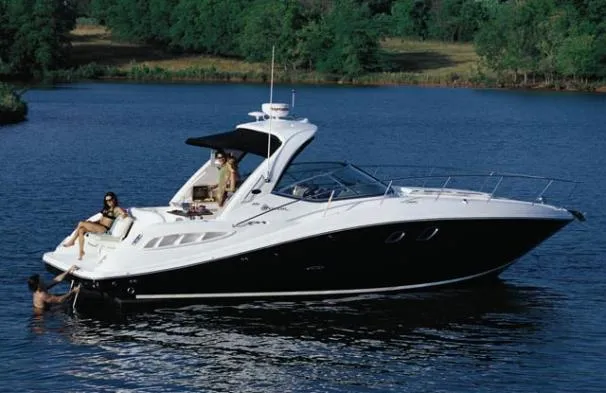 Slide: The Image of 2008 Sea Ray 330 Sundancer yacht on a serene lake with lush greenery. - 3