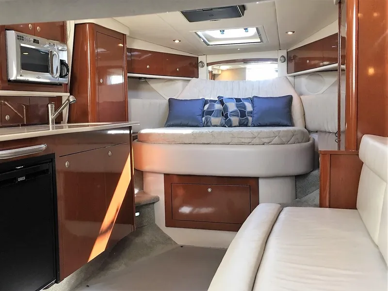 Slide: The Image of Luxurious 2008 Sea Ray 330 Sundancer cabin interior with bed, kitchenette, and seating area. - 30