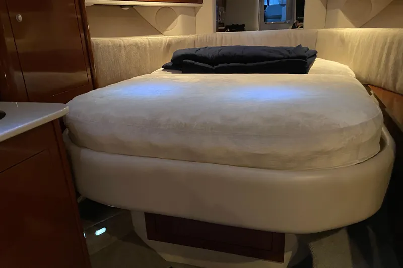 Slide: The Image of Interior cabin of 2008 Sea Ray 330 Sundancer with cozy bed and soft lighting. - 31