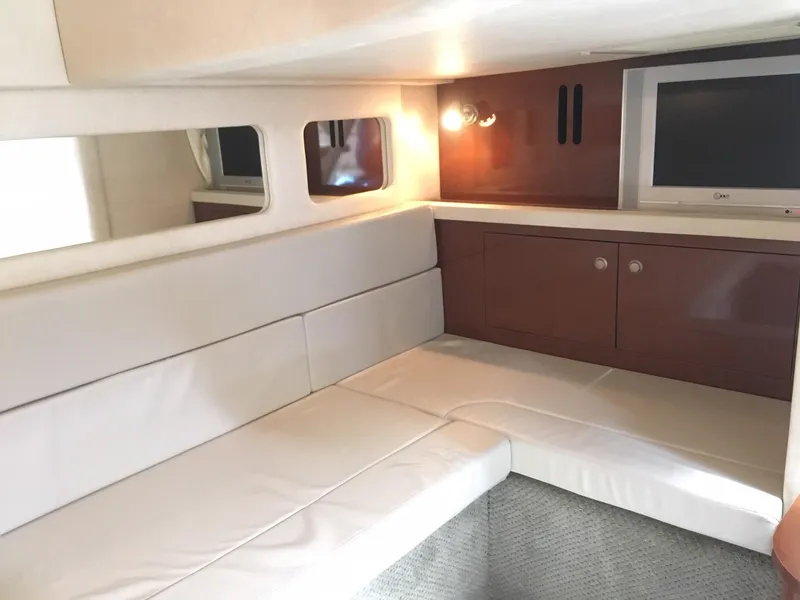 Slide: The Image of Interior of 2008 Sea Ray 330 Sundancer with white seating and built-in TV. - 33