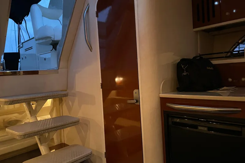 Slide: The Image of Interior of 2008 Sea Ray 330 Sundancer with stairs, seating, and kitchenette area. - 38