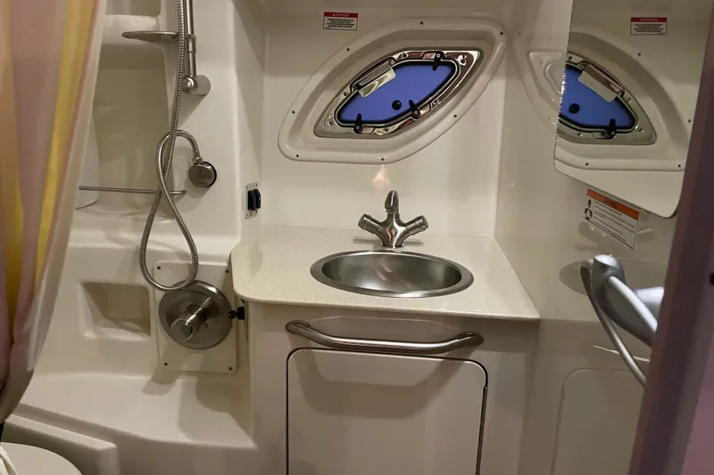 Slide: The Image of 2008 Sea Ray 330 Sundancer bathroom with sink, shower, and porthole window. - 39