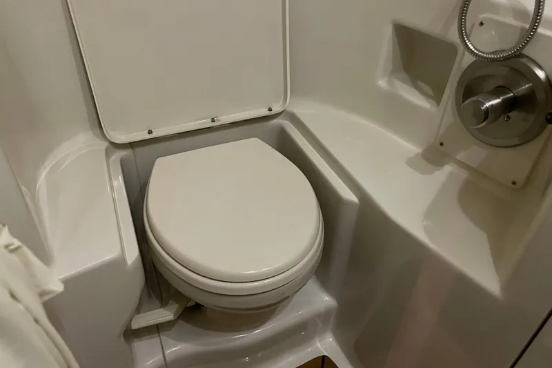 Slide: The Image of Compact bathroom in 2008 Sea Ray 330 Sundancer yacht, featuring a white marine toilet. - 40