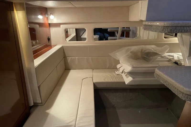 Slide: The Image of Interior of 2008 Sea Ray 330 Sundancer yacht with beige seating and wooden accents. - 43