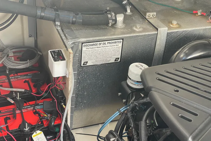 Slide: The Image of Engine compartment of 2008 Sea Ray 330 Sundancer with oil discharge warning. - 47