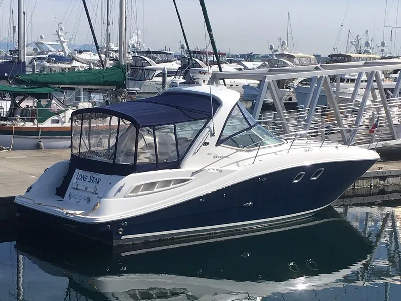 Slide: The Image of 2008 Sea Ray 330 Sundancer yacht docked at marina, featuring sleek design and blue canopy. - 6