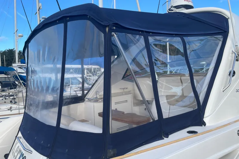 Slide: The Image of 2008 Sea Ray 330 Sundancer with blue canvas enclosure at marina. - 7