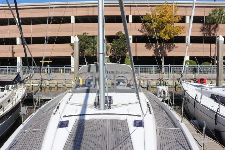 Slide: The Image of Cozy cabin interior of 2021 Beneteau Oceanis Yacht 54 with nautical-themed bedding. - 23