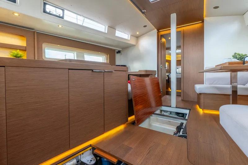 Slide: The Image of Luxurious interior of 2021 Beneteau Oceanis Yacht 54 with modern wood finishes and ambient lighting. - 44