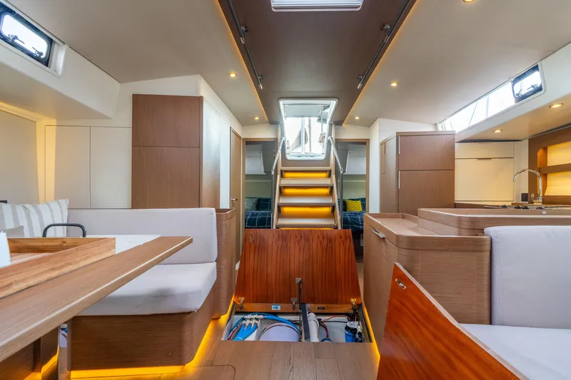 Slide: The Image of Luxurious interior of 2021 Beneteau Oceanis Yacht 54 with modern wood finishes and ambient lighting. - 46