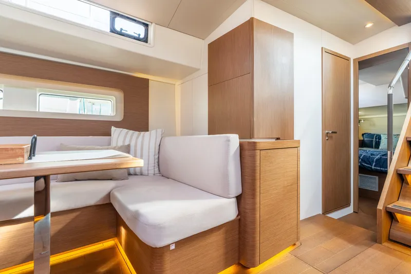 Slide: The Image of Interior of 2021 Beneteau Oceanis Yacht 54, featuring modern seating and wooden finishes. - 47