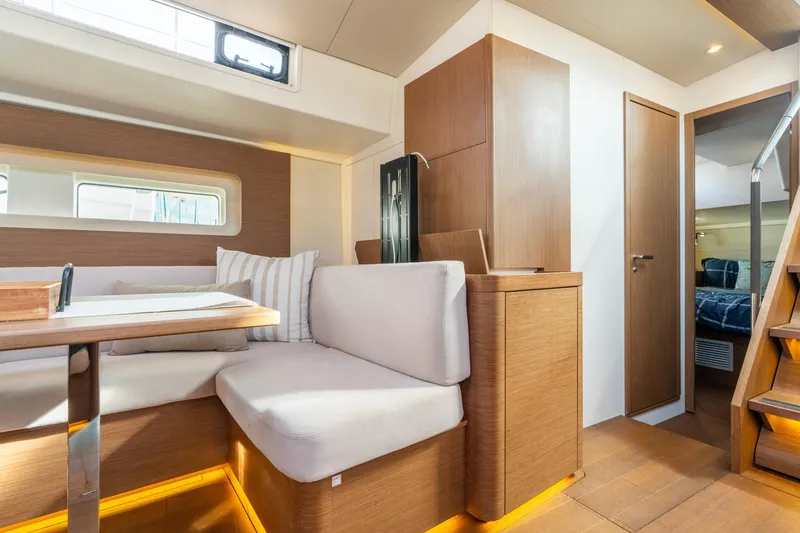 Slide: The Image of Interior of 2021 Beneteau Oceanis Yacht 54, featuring modern seating and wooden finishes. - 48