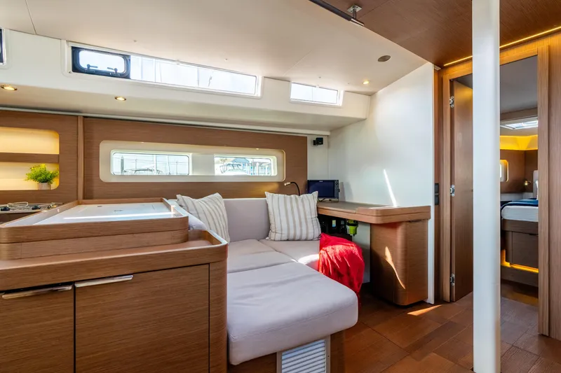 Slide: The Image of Luxurious interior of 2021 Beneteau Oceanis Yacht 54 with modern wood finishes and cozy seating. - 51