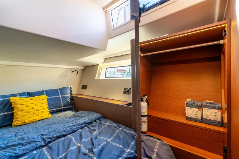 Slide: The Image of Cozy cabin interior of 2021 Beneteau Oceanis Yacht 54 with bed and storage. - 54