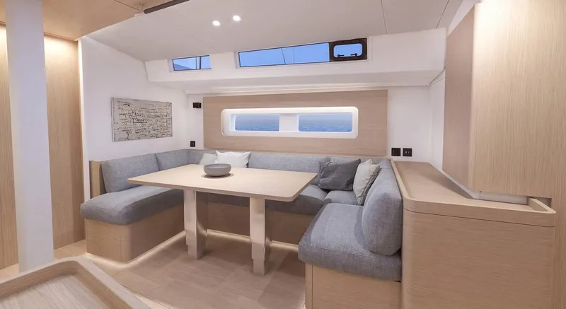 Slide: The Image of Luxurious interior of 2021 Beneteau Oceanis Yacht 54 with polished wood table and seating. - 6