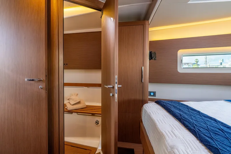 Slide: The Image of Luxurious interior of 2021 Beneteau Oceanis Yacht 54, featuring a cozy bedroom and bathroom. - 70