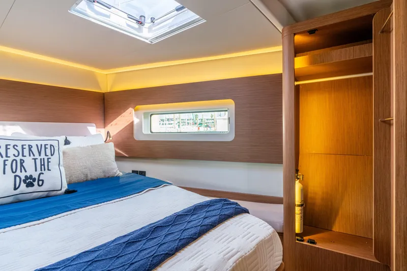 Slide: The Image of Luxurious cabin interior of 2021 Beneteau Oceanis Yacht 54 with cozy bedding and wooden accents. - 73