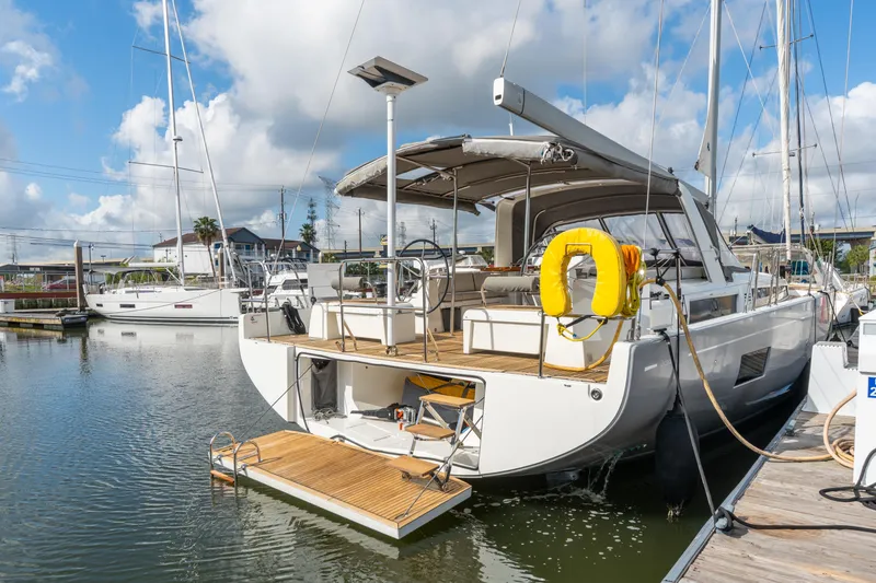 Slide: The Image of 2021 Beneteau Oceanis Yacht 54 docked, showcasing elegant design and spacious deck. - 78