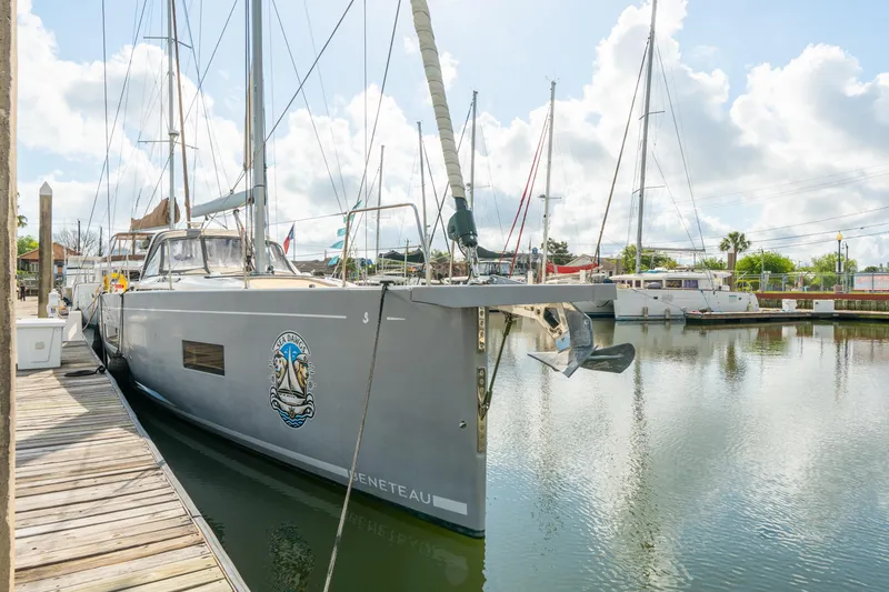Slide: The Image of 2021 Beneteau Oceanis Yacht 54 docked in a marina under a cloudy sky. - 81