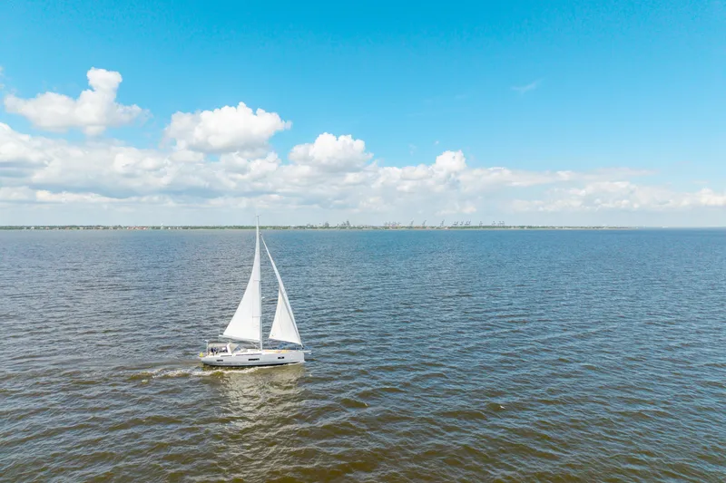 Slide: The Image of Sailing yacht Beneteau Oceanis Yacht 54, 2021 model, cruising on open water under blue sky. - 82