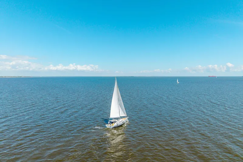 Slide: The Image of Sailing yacht Beneteau Oceanis Yacht 54, 2021 model, cruising on open sea under clear blue sky. - 83