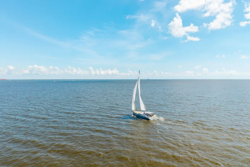 Slide: The Image of Sailing yacht Beneteau Oceanis Yacht 54, 2021 model, cruising on open sea under clear blue sky. - 85