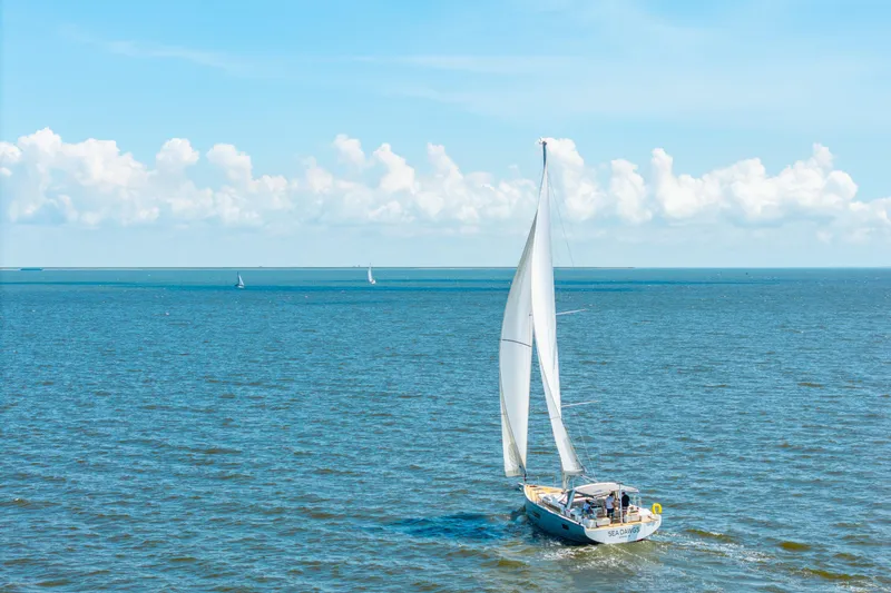 Slide: The Image of Sailing yacht Beneteau Oceanis Yacht 54, 2021 model, cruising on open sea under clear skies. - 86