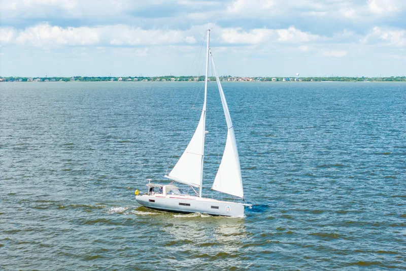 Slide: The Image of 2021 Beneteau Oceanis Yacht 54 sailing on open water under a cloudy sky. - 88