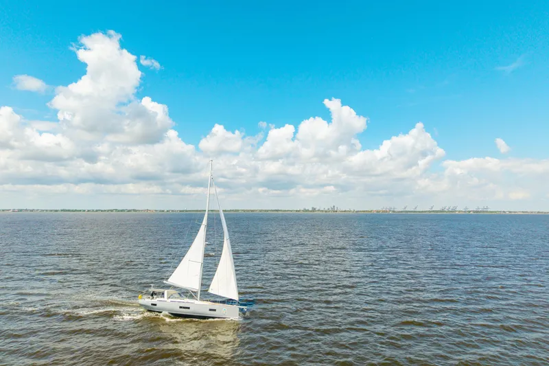 Slide: The Image of 2021 Beneteau Oceanis Yacht 54 sailing on open water under a clear blue sky. - 89