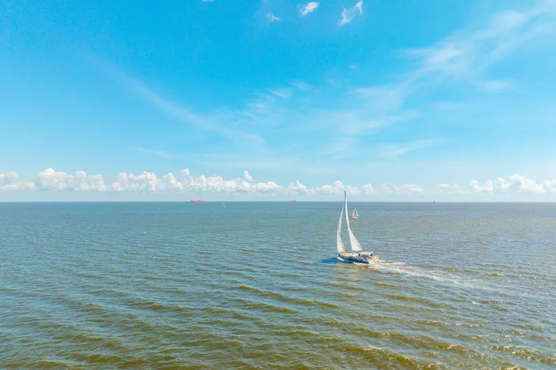 Slide: The Image of Sailing yacht Beneteau Oceanis Yacht 54, 2021 model, cruising on open sea under clear blue sky. - 91