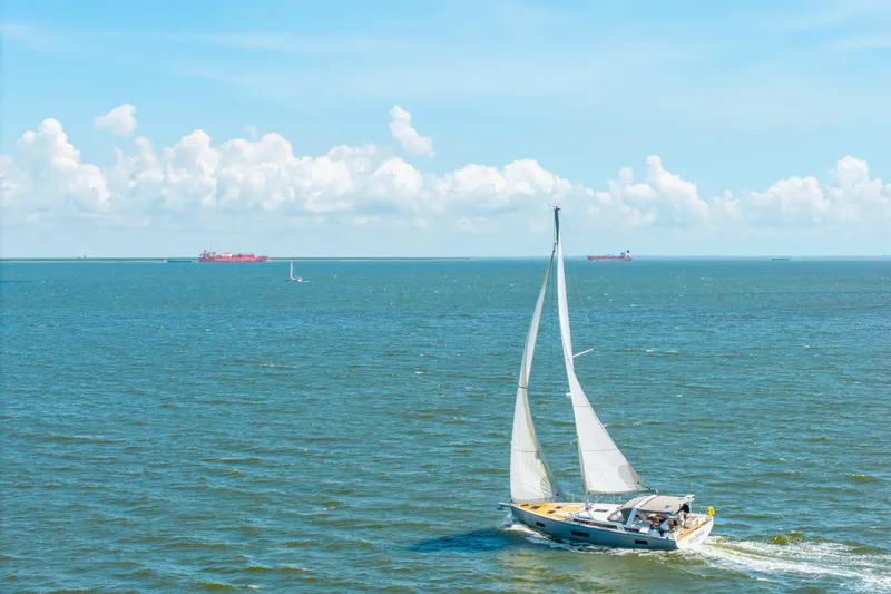Slide: The Image of Sailing yacht Beneteau Oceanis Yacht 54, 2021 model, cruising on open sea under clear skies. - 93