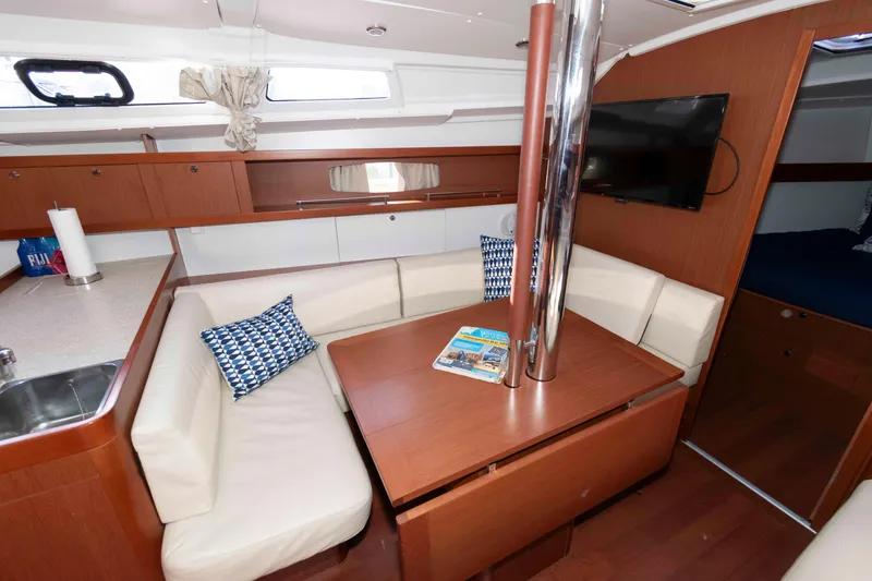 Slide: The Image of Interior of 2015 Beneteau Oceanis 37 yacht with cozy seating and modern amenities. - 10